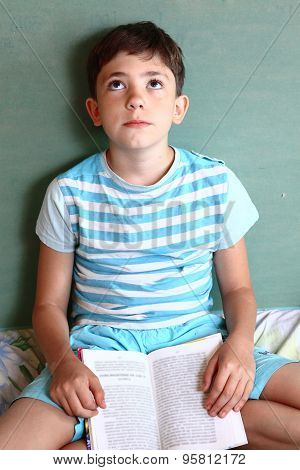 preteens handsome boy with book tired closed hes eyes