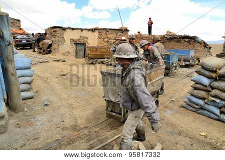 Potosi, Bolivia - 24 November 2012: Miners are standing just outside of the entrance to Cerro Rico mine, Potosi. Cerro Rico has a long history for the extraction of rich deposits of silver.