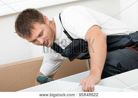 Man Putting Together Self Assembly Furniture
