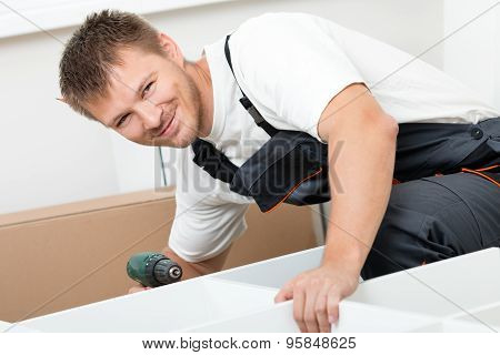 Man Putting Together Self Assembly Furniture