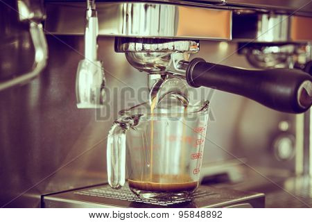 Prepares espresso in coffee shop ( Filtered image processed vintage effect. )