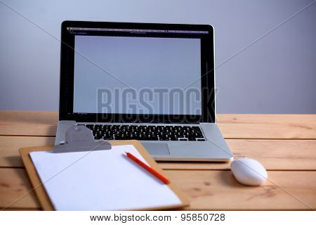 Laptop stands on a wooden table