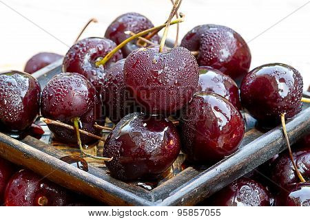 Close Up Of Cherry And Water Droplets Clinging To Skin.