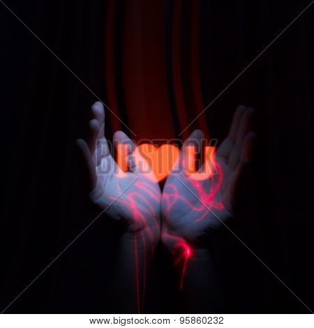 Light Painting Photography. Freezelight Photo. Hands Holding A Glowing Massage With Freezelight Effe
