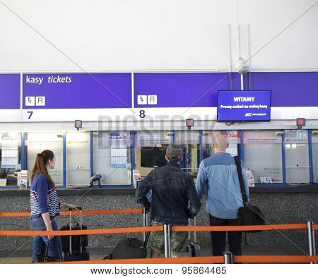 WARSAW, POLAND - SATURDAY, JUNE 6, 2015: Passengers on line to purchase tickets inside the main Polrail, PKP, train station in Warsaw.  