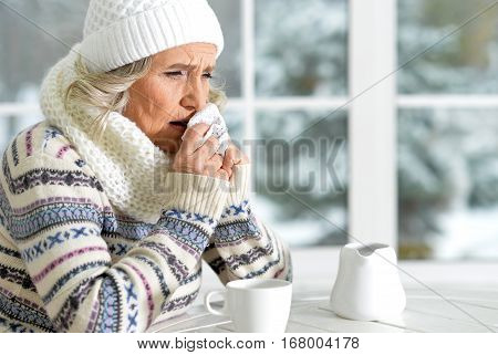 mature woman feeling herself bad sitting in cafe