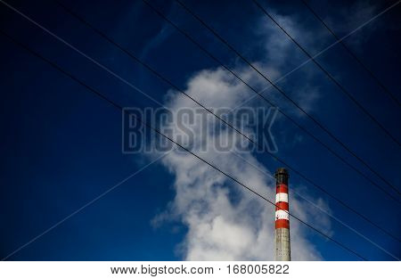 thermal energy plant chimney with a blue sky