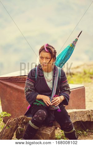 SAPA, VIETNAM - OCTOBER 29, 2012: Hmong women sell souvenirs in Sapa. The Hmongs are known for their colorful clothes and silver jewelry. Hmong women have various clothes colours and style