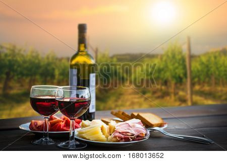 still life Red wine ,cheese and prosciutto. Romantic dinner outdoors