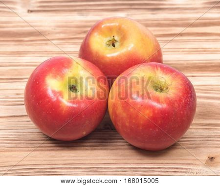 Ripe organic kanzi apple on vintage wooden tray