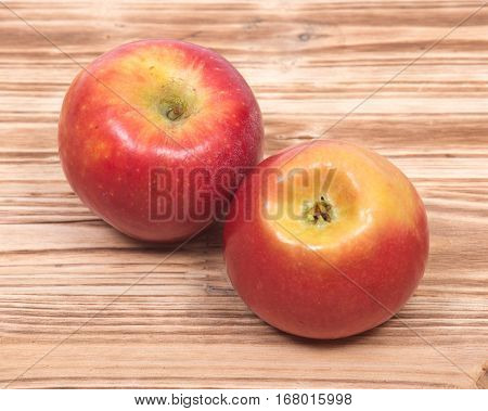 Ripe organic kanzi apple on vintage wooden tray