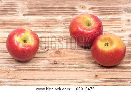Ripe organic kanzi apple on vintage wooden tray