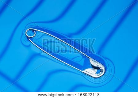 Physical experiment - pin floating on water surface.