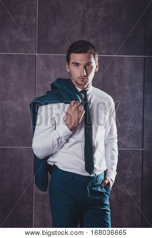 Stylish Handsome Young Man Holding Jaket On Shoulder