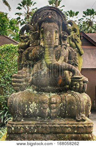 Old moss stone statue of Ganesha a hindu symbol, Bali, Indonesia.