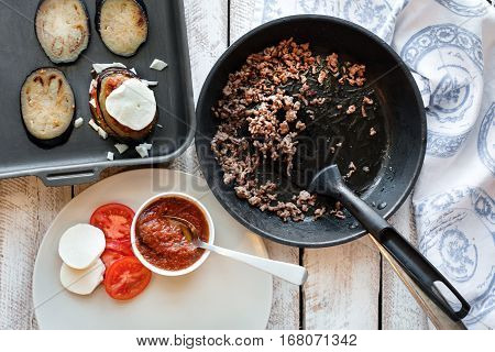 Ingredients for cooking Parmigiana di melanzane: baked eggplant - italy, sicily cousine. On the wooden table.