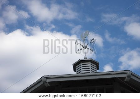 Blue sky with wind wheel on rooftop church with white clouds on clear blue sky day / wind wheel roof sky