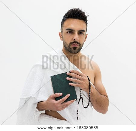 Muslim man posing as ready for Hajj visiting Kaaba in Mecca