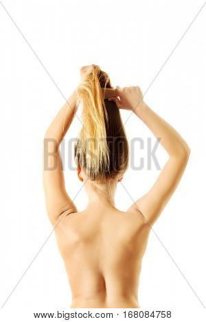Photo of combing woman with long blond hair