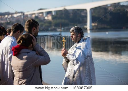 PORTO, PORTUGAL - JAN 19, 2017: Celebrating Baptism of Jesus and Epiphany bathing in Douro river in the Parish of Russian Orthodox Church. This is one of the holiest holidays for all Christians.