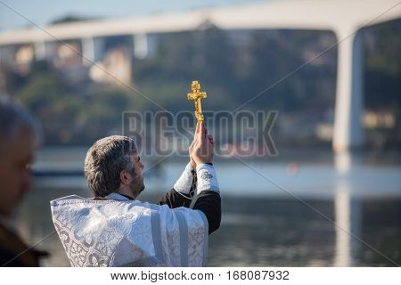 PORTO, PORTUGAL - JAN 19, 2017: Celebrating Baptism of Jesus and Epiphany bathing in Douro river in the Parish of Russian Orthodox Church. This is one of the holiest holidays for all Christians.