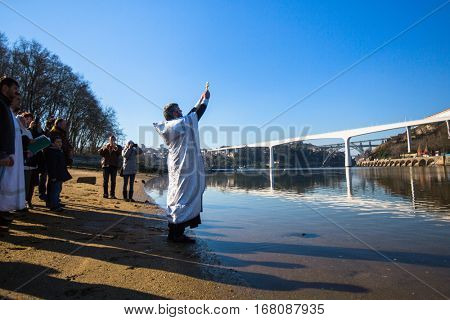 PORTO, PORTUGAL - JAN 19, 2017: Celebrating Baptism of Jesus and Epiphany bathing in Douro river in the Parish of Russian Orthodox Church. This is one of the holiest holidays for all Christians.