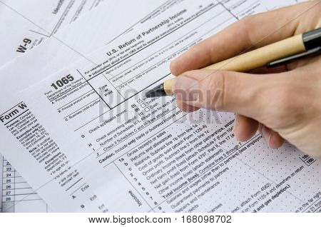 man filling Tax forms 1065 close up