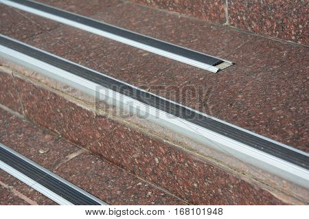 Close up on stair treads and rubber landing tiles provide slip-resistant stair protection and safe footing to help prevent falls. Rubber stair protection.