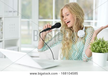 Portrait of a teen girl singing into a microphone