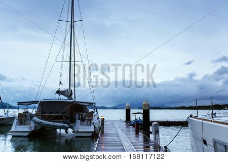 Catamaran on the pier. Romance of the seas