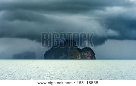 Island in the storm. Cyclone Sea. Storm on the horizon