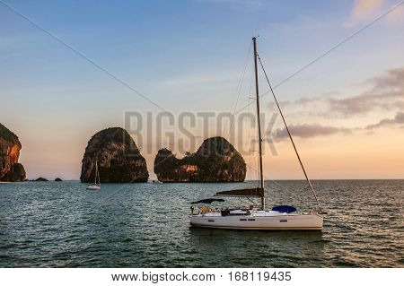 Yacht at sunset. Yacht on the islands background