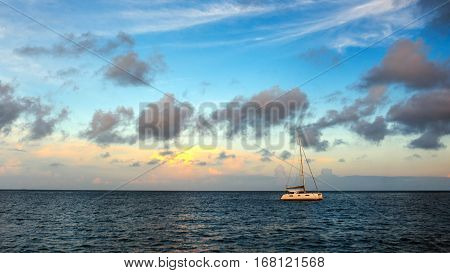 Sailing yacht at sunrise. A lonely yacht in the sea