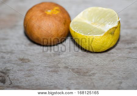 Lemon ripe withered unappetizing. Brown was placed on the wooden floor.