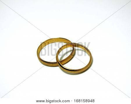 Couple of gold wedding rings on white background isolated