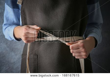 Woman  tying up her apron around the waist