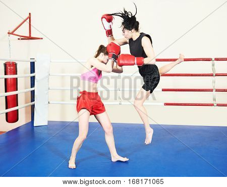 Muay thai woman fighting at boxing ring