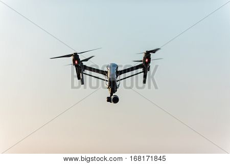 quadrocopter drone with remote control. Dark silhouette against colorfull sunset. Soft focus. Toned image