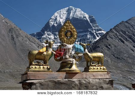 The main Buddhist symbol Dharmachakra on the roof of Buddhist monastery Driraphuk gompa at the North Face of sacred Mount Kailash in Western Tibet.