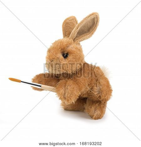 Rabbit toy with a brush on the white background