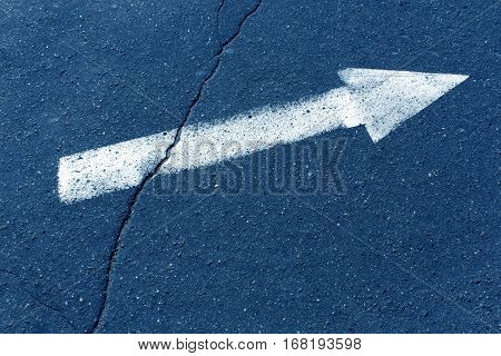 White Arrow On Blue Asphalt Surface.
