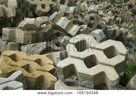 Brick paved walkway bricks, some are piled together.