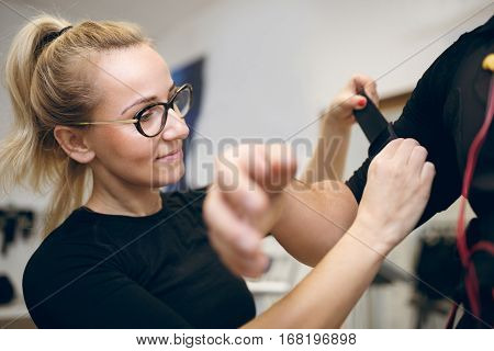 Beautiful Woman Fastening Belt On Man Arm