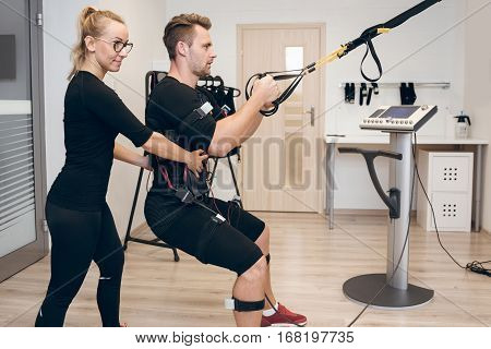 Concentrated Man Working Out Ems Training With His Coach