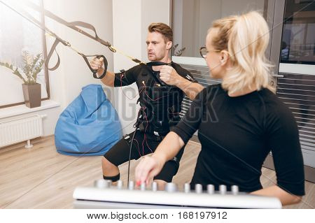 Man Concentrated On Training And His Personal Coach Looking At Him
