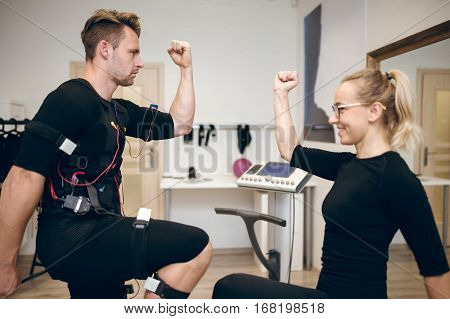 Young Sportsman Training With Personal Coach At Gym