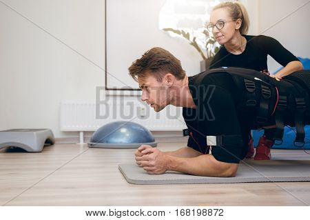 Sportsman Working Out On The Floor With Personal Coach