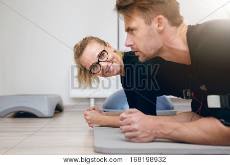 Smiling Woman At The Gym Looking At The Sportsman