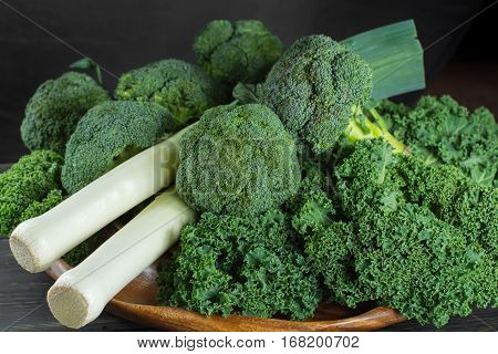 Green winter fresh organic superfood - Kale green cabbage broccoli and leeks prei