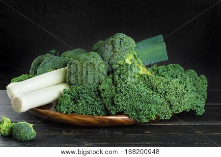 Green winter fresh organic superfood - Kale green cabbage broccoli and leeks prei